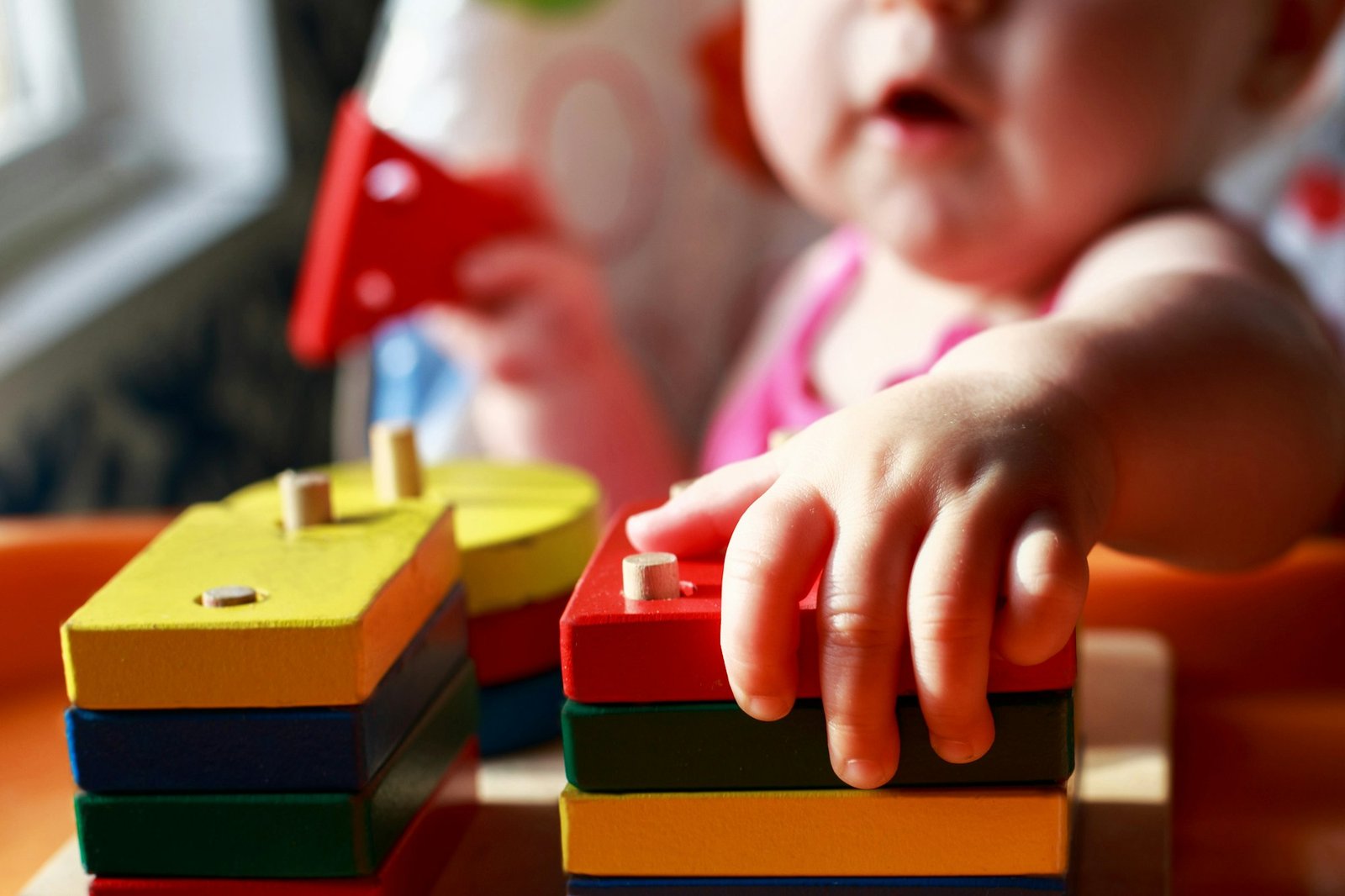 the child plays with an educational toy